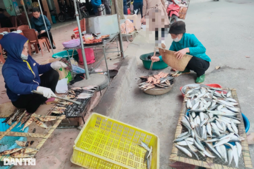 Grilling fish at the foot of a sacred temple in Nghe An